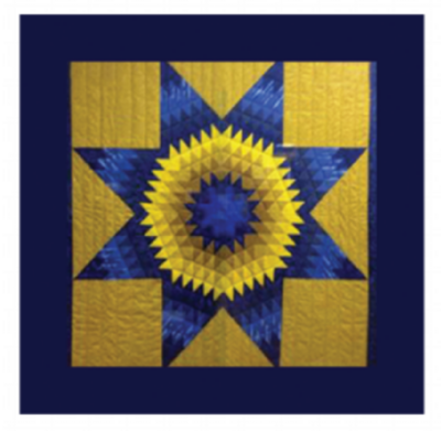 TMU Star blanket. Blue and yellow quitled blanket with blue background and yellow star.